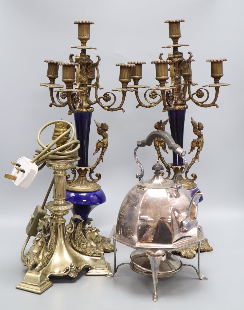 A pair of gilt metal and porcelain five light candelabra, height 50cm, a table lamp and a kettle on stand